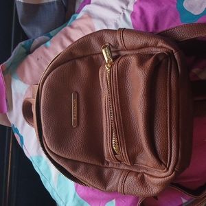 Steve Madden Brown backpack has 2 pockets and 1 in the inside
